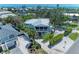 Charming coastal home with a white metal roof, screened porch, and lush tropical landscaping at 733 Holly Rd, Anna Maria, FL 34216