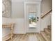 Inviting foyer with wood-look tile flooring, decorative table, and a staircase to the right at 733 Holly Rd, Anna Maria, FL 34216