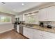 Bright kitchen featuring stainless steel appliances, granite countertops, and natural light at 733 Holly Rd, Anna Maria, FL 34216