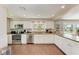 Modern kitchen with stainless steel appliances, granite countertops, and white cabinetry at 733 Holly Rd, Anna Maria, FL 34216