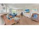 Beautiful living room with wicker chairs, blue couch, and beachy decor at 733 Holly Rd, Anna Maria, FL 34216