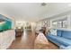 Inviting living room featuring hardwood floors, comfortable seating, and access to the dining area at 733 Holly Rd, Anna Maria, FL 34216