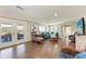Cozy living room with blue furniture, wood floors, and access to an outdoor deck at 733 Holly Rd, Anna Maria, FL 34216