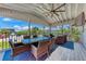 Covered patio with dining and seating areas, perfect for outdoor entertaining and enjoying the view at 733 Holly Rd, Anna Maria, FL 34216