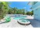 Backyard pool and spa area with mature landscaping offers a luxurious retreat at 733 Holly Rd, Anna Maria, FL 34216