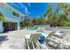 Backyard pool area with lounge chairs, table, and lush landscaping for relaxing and entertaining at 733 Holly Rd, Anna Maria, FL 34216