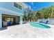 Backyard pool with sundeck area, bar, and beautiful landscaping for relaxing and entertaining at 733 Holly Rd, Anna Maria, FL 34216