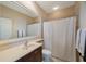 Clean bathroom featuring a shower with tile surround, sink, and mirror at 7615 Charleston St, Bradenton, FL 34201