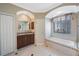Bright bathroom featuring a soaking tub, walk-in shower, and double sink vanity at 7615 Charleston St, Bradenton, FL 34201