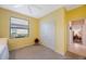 Bright bedroom with yellow walls, carpeted floor, closet, and window at 7615 Charleston St, Bradenton, FL 34201