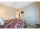 Bedroom with a ceiling fan, double closets, and floral bedspread at 7615 Charleston St, Bradenton, FL 34201