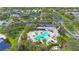 Aerial view of the community pool and amenity center, including a playground and lush landscaping at 7615 Charleston St, Bradenton, FL 34201