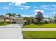 Charming single-story home with a manicured lawn, mature palm trees, and a spacious driveway at 7615 Charleston St, Bradenton, FL 34201