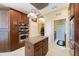 Bright kitchen features stainless steel appliances, center island, and opens to adjacent rooms at 7615 Charleston St, Bradenton, FL 34201