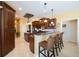 Spacious kitchen features seating at the breakfast bar and modern pendant lighting at 7615 Charleston St, Bradenton, FL 34201
