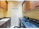 Laundry room with sink, washer, dryer, and upper cabinets for storage space at 7615 Charleston St, Bradenton, FL 34201