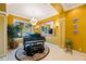 Bright living room featuring large windows, a baby grand piano, elegant décor, and tile flooring at 7615 Charleston St, Bradenton, FL 34201
