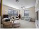 Spacious living room featuring comfortable furniture, ceiling fan, and bright windows at 7615 Charleston St, Bradenton, FL 34201