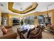 Open living room flows to the lanai featuring a tray ceiling and comfortable seating area at 7615 Charleston St, Bradenton, FL 34201