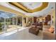 Open living room with lanai access, tray ceilings and easy access to kitchen and dining at 7615 Charleston St, Bradenton, FL 34201