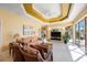Bright living room with tray ceiling, comfortable seating, and access to the lanai at 7615 Charleston St, Bradenton, FL 34201