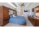 Comfortable main bedroom with a blue bedspread, a tray ceiling, and a ceiling fan at 7615 Charleston St, Bradenton, FL 34201