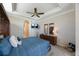 Comfortable main bedroom featuring a tray ceiling and a ceiling fan at 7615 Charleston St, Bradenton, FL 34201