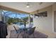 A view of the patio with a round table set, a grill, and overlooking the pool and surrounding backyard at 7615 Charleston St, Bradenton, FL 34201