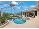 Stunning pool area featuring clear blue water, a screened enclosure, and lush landscaping at 7615 Charleston St, Bradenton, FL 34201