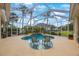 Relaxing screened-in pool area with comfortable seating and view of the lush backyard at 7615 Charleston St, Bradenton, FL 34201
