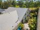 Aerial shot showcasing a well-maintained roof, arched windows, landscaped garden, and a cozy backyard patio space at 7716 Geneva Ln, Sarasota, FL 34243