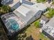 Overhead view of a home with a screened pool enclosure and a lush backyard, in a well-kept residential neighborhood at 7716 Geneva Ln, Sarasota, FL 34243