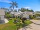 Charming single-story home featuring well-maintained landscaping and a welcoming front entrance with beautiful palm tree at 7716 Geneva Ln, Sarasota, FL 34243