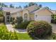 Charming single-story home featuring well-maintained landscaping with flowers at 7716 Geneva Ln, Sarasota, FL 34243