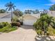Charming home with a well-manicured lawn, mature landscaping, and a two-car garage, radiating curb appeal at 7716 Geneva Ln, Sarasota, FL 34243