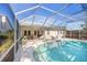 Screened-in outdoor pool with patio, ideal for relaxation and enjoying the beautiful sunny weather at 7716 Geneva Ln, Sarasota, FL 34243