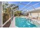 Screened-in outdoor pool with patio, ideal for relaxation and enjoying the beautiful sunny weather at 7716 Geneva Ln, Sarasota, FL 34243