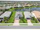 Aerial view of a charming home with a brick driveway, manicured landscaping, and a spacious front lawn at 7758 Summerland Cv, Bradenton, FL 34202