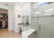 Bathroom showcasing a glass shower, makeup vanity with mirror, and a walk-in closet at 7758 Summerland Cv, Bradenton, FL 34202