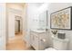 Bathroom boasts a modern vanity, mirror, and framed artwork, enhancing a clean, inviting space at 7758 Summerland Cv, Bradenton, FL 34202