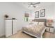 Tastefully decorated bedroom featuring a modern dresser, stylish lamps, and a soothing color palette at 7758 Summerland Cv, Bradenton, FL 34202