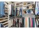 Walk-in closet with custom shelving for optimal storage of clothes, shoes and accessories at 7758 Summerland Cv, Bradenton, FL 34202