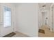 Bright foyer with decorative glass front door leading into a hallway with wood floors at 7758 Summerland Cv, Bradenton, FL 34202