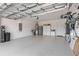 Spacious garage with epoxy flooring, overhead storage, refrigerator, and ample storage solutions at 7758 Summerland Cv, Bradenton, FL 34202