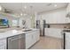 Bright kitchen with stainless steel appliances, ample cabinet space, and open layout to the living area at 7758 Summerland Cv, Bradenton, FL 34202