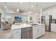 Modern kitchen featuring a large island, stainless steel appliances, and an open layout to the living area at 7758 Summerland Cv, Bradenton, FL 34202