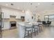 Modern kitchen with stainless steel appliances, a large island with seating, and stylish pendant lighting at 7758 Summerland Cv, Bradenton, FL 34202
