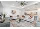 Bright, neutral living room with wood floors, a tray ceiling, and an open floor plan at 7758 Summerland Cv, Bradenton, FL 34202