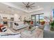 Bright and spacious living room with modern furnishings and an open floor plan to the kitchen and dining area at 7758 Summerland Cv, Bradenton, FL 34202