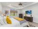Bedroom showcasing a large window, stylish furnishings, and a serene view of the lush landscape at 7758 Summerland Cv, Bradenton, FL 34202